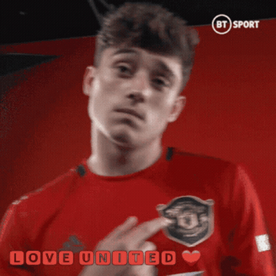 A Man In A Red Shirt With The Words Love United Written On It GIF