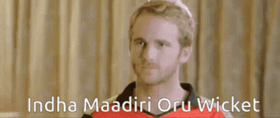 A Man In A Red Shirt With The Words ' Ndha Madiri Oru Wicket ' On The Bottom GIF