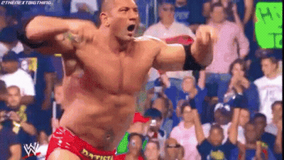 A Man In A Red Shorts Is Standing In Front Of A Crowd . GIF