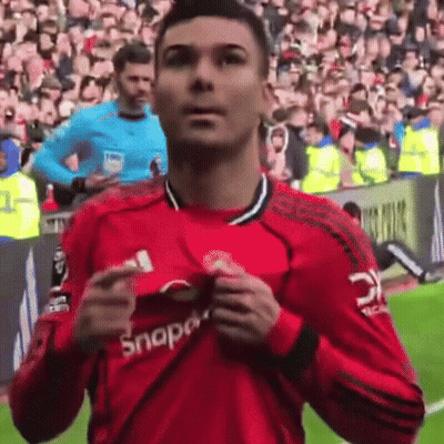 A Man In A Red Snap On Shirt Stands On A Field GIF