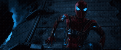 A Man In A Red Spiderman Costume Is Running In The Dark GIF