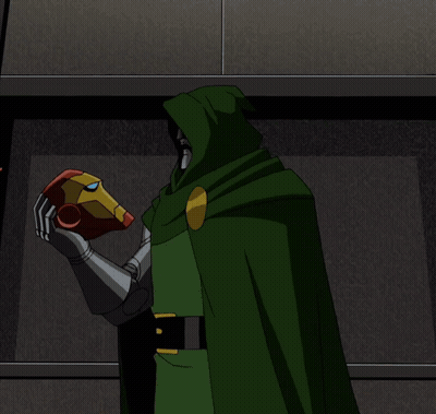 A Man In A Red Suit And A Man In A Green Cape Standing Next To Each Other GIF