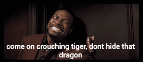 A Man In A Red Suit And Tie Says Come On Crouching Tiger Dont Hide That Dragon GIF