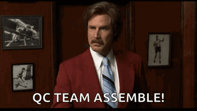 a man in a red suit and tie says qc team assemble !