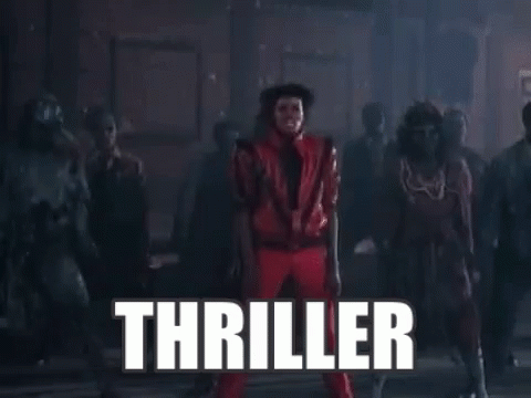 A Man In A Red Suit Is Dancing In Front Of A Crowd Of People With The Word Thriller Written In White Letters . GIF