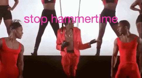 A Man In A Red Suit Is Dancing On A Stage With A Group Of Dancers Behind Him . GIF