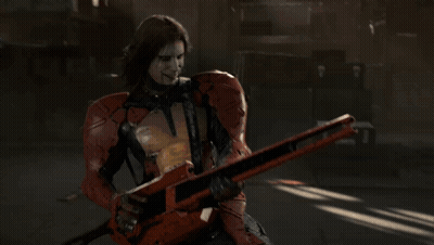 A Man In A Red Suit Is Holding A Guitar GIF