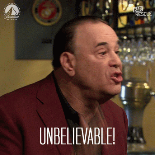 Man In Red Suit Making Unbelievable Face GIF