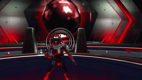 A Man In A Red Suit Is Standing In Front Of A Red Ball GIF
