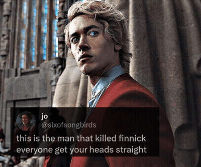 A Man In A Red Suit Stands In Front Of A Stained Glass Window GIF