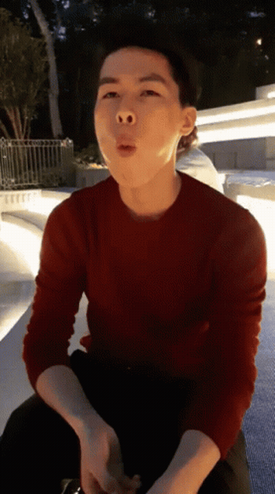 A Man In A Red Sweater Is Making A Face GIF