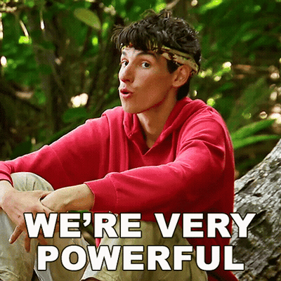 A Man In A Red Sweatshirt Sits On A Tree Trunk With The Words " We 'Re Very Powerful " Written Below Him GIF