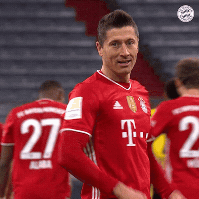 A Man In A Red T-Mobile Jersey Stands In Front Of A Group Of Soccer Players GIF