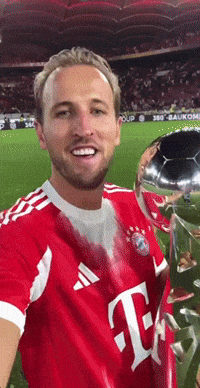 A Man In A Red T-Mobile Shirt Holds A Soccer Ball GIF