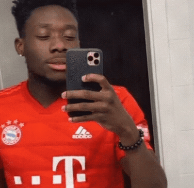 A Man In A Red T-Mobile Shirt Takes A Selfie With His Phone GIF