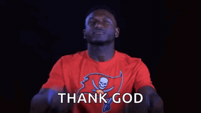 A Man In A Red T-Shirt Is Pointing Up With His Fingers And Saying Thank God . GIF