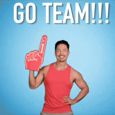 A Man In A Red Tank Top Holds Up A Foam Finger And Says " Go Team " GIF