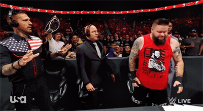A Man In A Red Tank Top With The Word Revolution On It Stands In Front Of A Crowd GIF