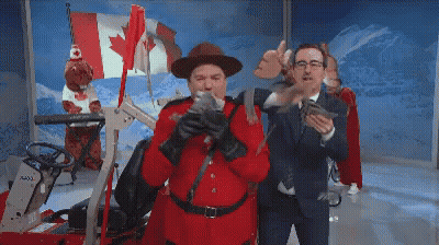 A Man In A Red Uniform Is Holding A Gun GIF