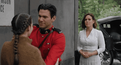 A Man In A Red Uniform Is Hugging A Girl In A Braid GIF