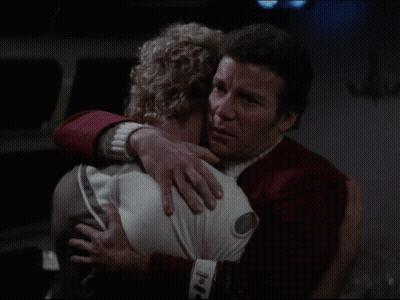 A Man In A Red Uniform Is Hugging A Woman GIF
