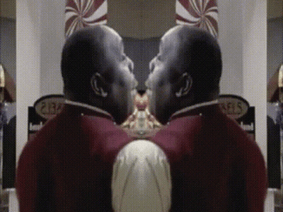 A Man In A Red Uniform Is Standing In Front Of A Sign That Says ' Pears ' GIF