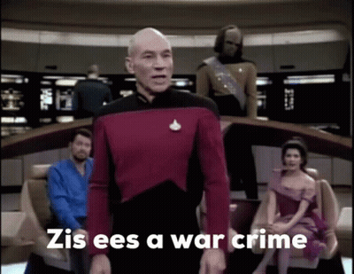 A Man In A Red Uniform Stands In Front Of A Group Of People And Says Zis Ees A War Crime . GIF