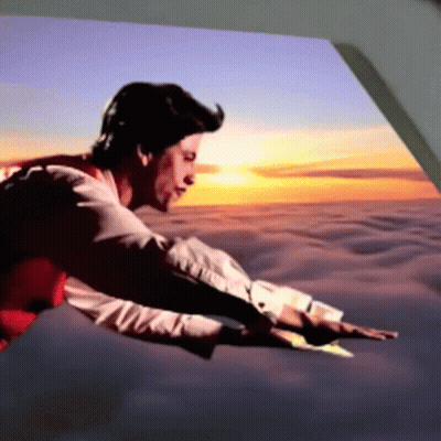 A Man In A Red Vest Is Flying Through The Air At Sunset GIF