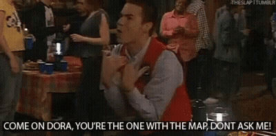 A Man In A Red Vest Is Kneeling In Front Of A Crowd And Says Come On Dora You 'Re The One With The Map GIF