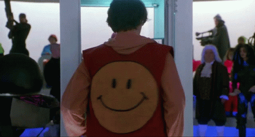 A Man In A Red Vest With A Smiley Face On It GIF