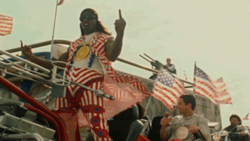 A Man In A Red White And Blue Striped Outfit Giving The Middle Finger GIF