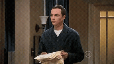 A Man In A Robe Is Holding A Stack Of Papers In Front Of A Cbs Sign GIF
