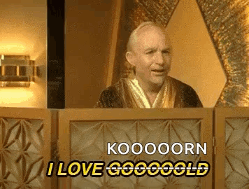 A Man In A Robe Is Standing Behind A Podium And Saying Koooooorn I Love Gogoold GIF