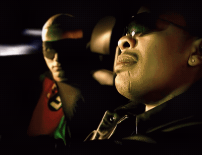 A Man In A Robin Costume Sits Next To Another Man In A Black Jacket GIF