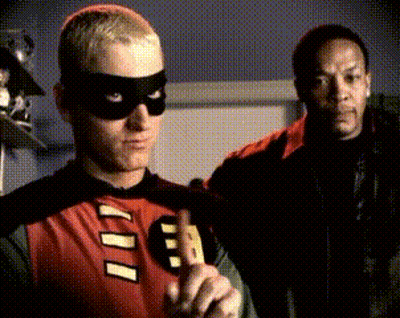 A Man In A Robin Costume With The Letter B On It GIF