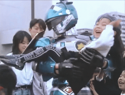 A Man In A Robot Costume Is Carrying A Woman In His Arms . GIF