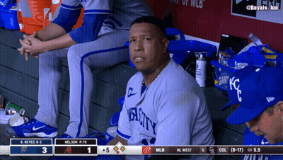 A Man In A Royals Jersey Sits In The Dugout Watching A Baseball Game GIF
