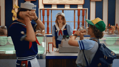 A Man In A Sailor Hat Stands In Front Of A Woman In A Sailor Costume GIF