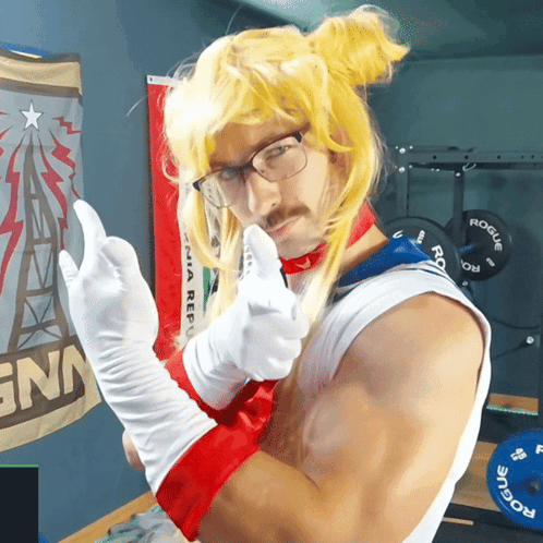 A Man In A Sailor Moon Costume Is Giving The Middle Finger In Front Of A Sign That Says Rogue GIF
