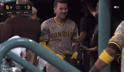 A Man In A San Diego Jersey Stands In Front Of A Scoreboard GIF