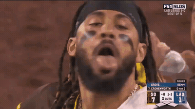 A Man In A San Diego Jersey Stands In The Dugout During A Baseball Game GIF