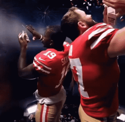 A Man In A San Francisco 49Ers Jersey Is Holding A Cigarette GIF