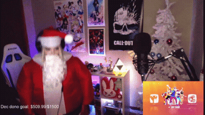 A Man In A Santa Costume Stands In Front Of A Microphone In A Room With A Call Of Duty Poster On The Wall GIF