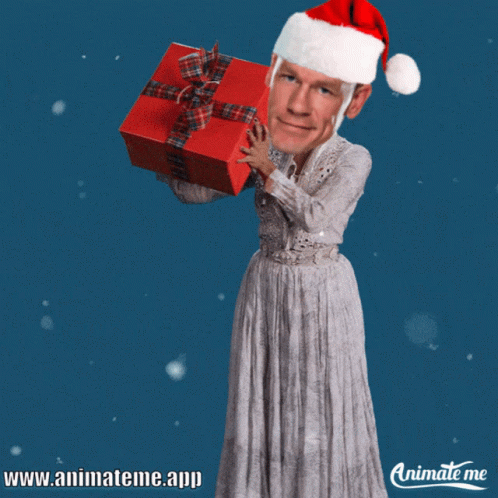 A Man In A Santa Hat Is Holding A Red Gift GIF