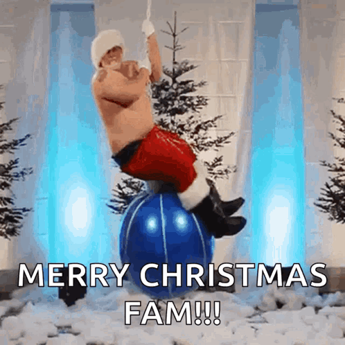 A Man In A Santa Suit Is Balancing On A Blue Christmas Ball GIF