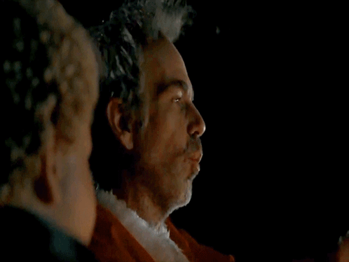 A Man In A Santa Suit Is Being Asked If He Is You GIF