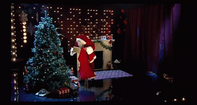 A Man In A Santa Suit Is Holding A Christmas Card With A Christmas Tree On It GIF