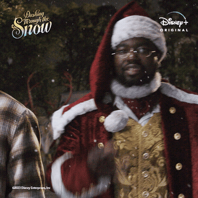 A Man In A Santa Suit Is Standing In Front Of A Sign That Says Dash Through The Snow GIF