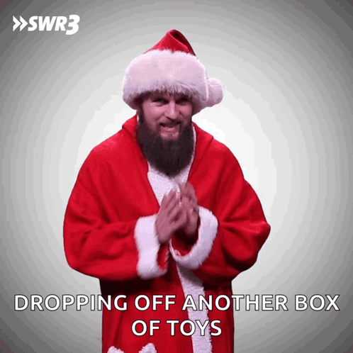 A Man In A Santa Suit Says Dropping Off Another Box Of Toys On A White Background GIF