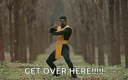 A Man In A Scorpion Costume Is Holding A Sword In A Forest And Says `` Get Over Here '' . GIF
